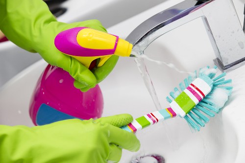 Domestic cleaner preparing a tidy kitchen in a Hackney home