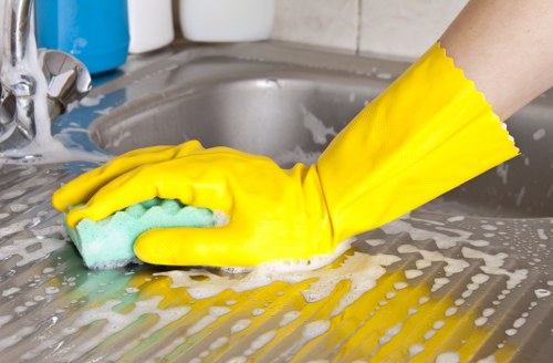 Deep cleaning kitchen and bathroom during a Hackney move out clean